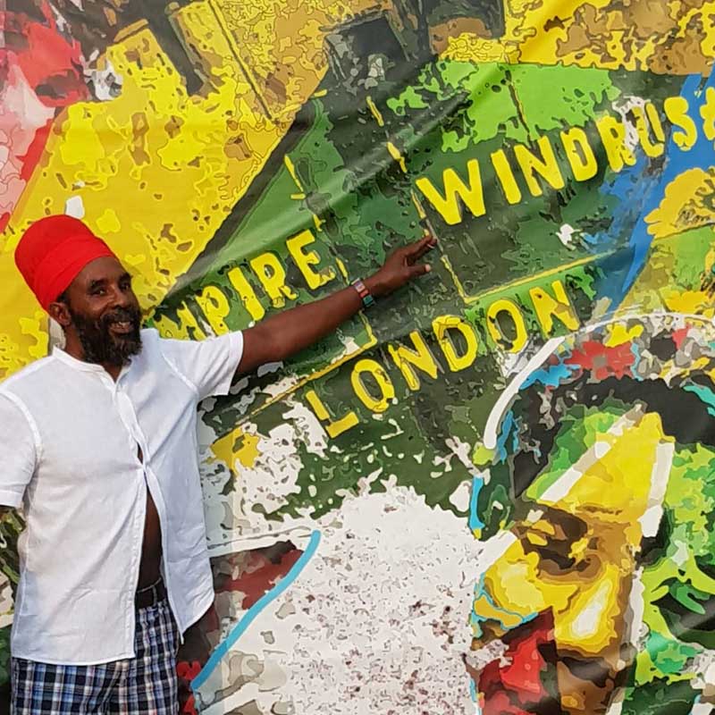 rasta man pointing to Windrush mural